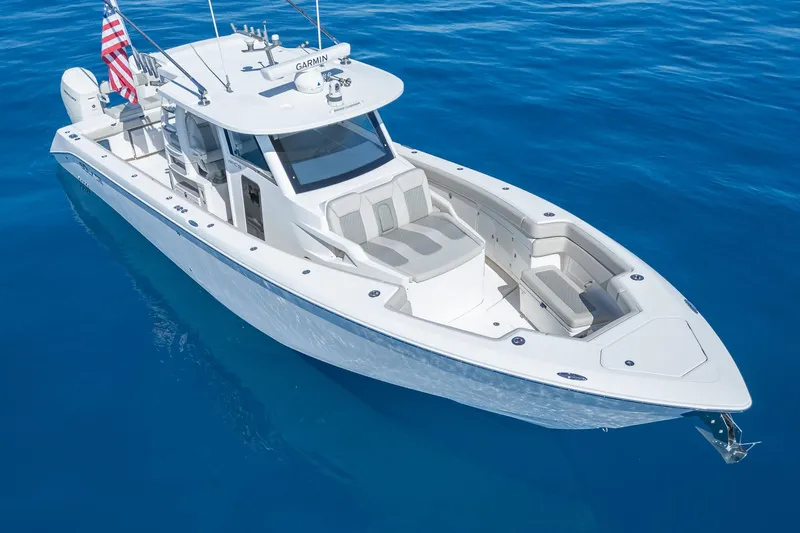 Slide: The Image of 2024 Solace 41 CS boat on clear blue water, showcasing sleek design and spacious deck. - 5