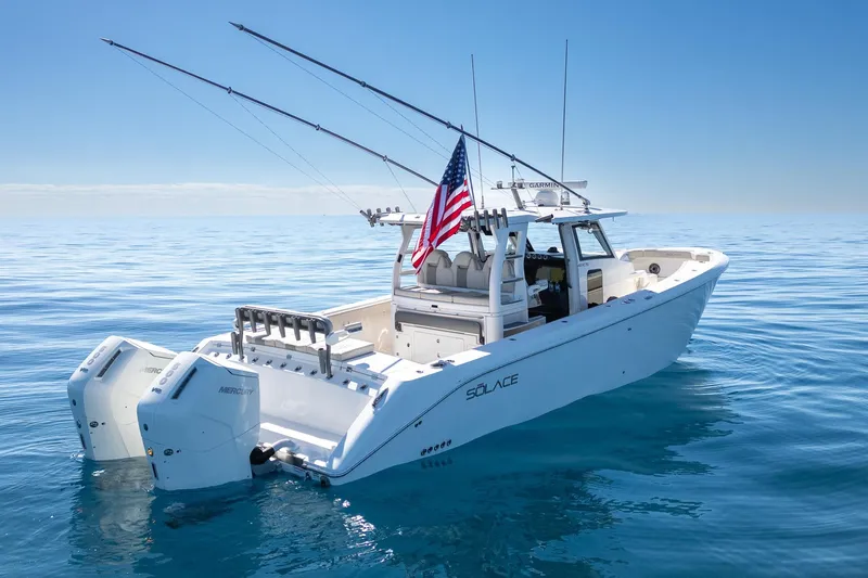 Slide: The Image of 2024 Solace 41 CS boat on calm ocean, featuring dual Mercury engines and fishing rods. - 6