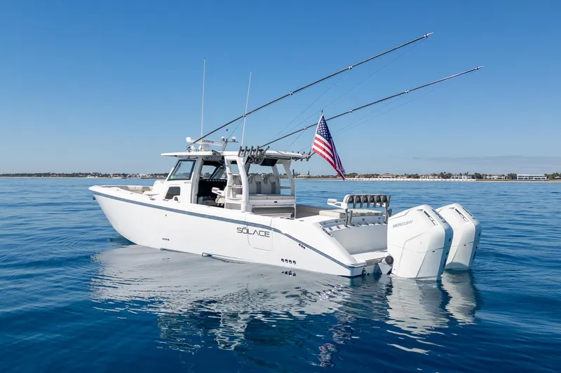 Slide: The Image of 2024 Solace 41 CS boat on calm blue water, featuring dual Mercury engines. - 7