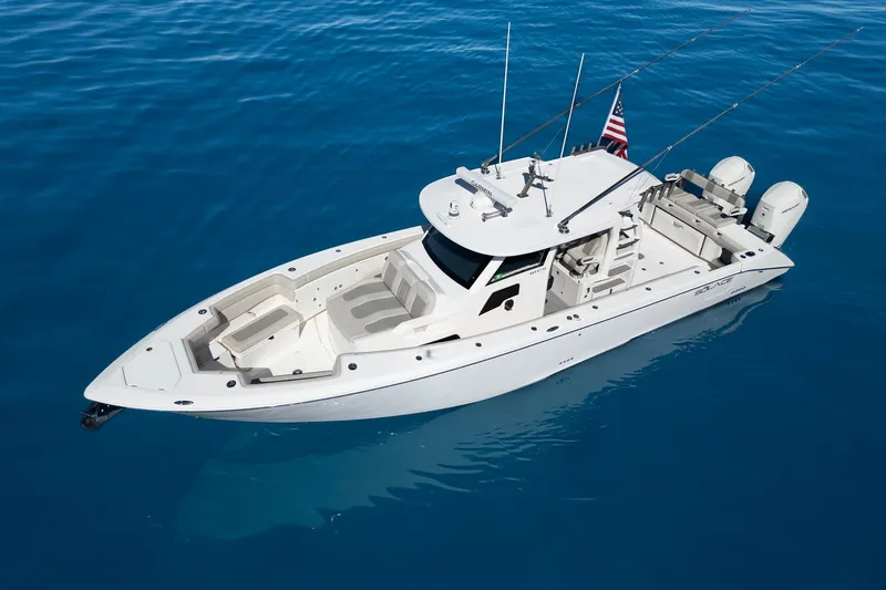 Slide: The Image of 2024 Solace 41 CS boat on clear blue water, featuring sleek design and twin engines. - 8