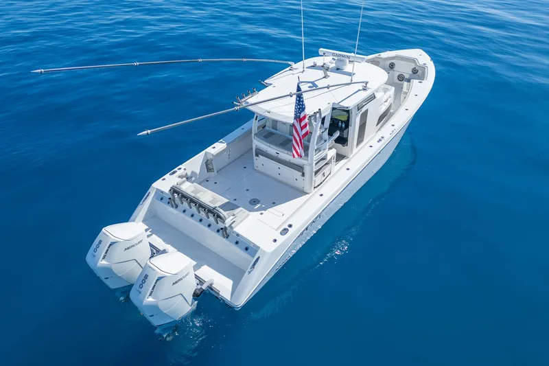 Slide: The Image of 2024 Solace 41 CS boat on clear blue water, featuring dual Mercury engines. - 9