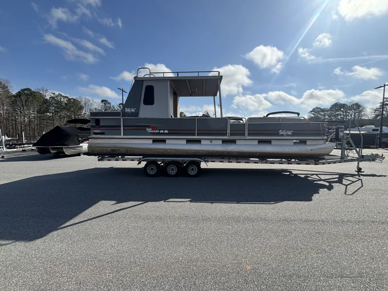 The Image of 1990 Sun Tracker Party Hut 28 on trailer under sunny skies. - 1