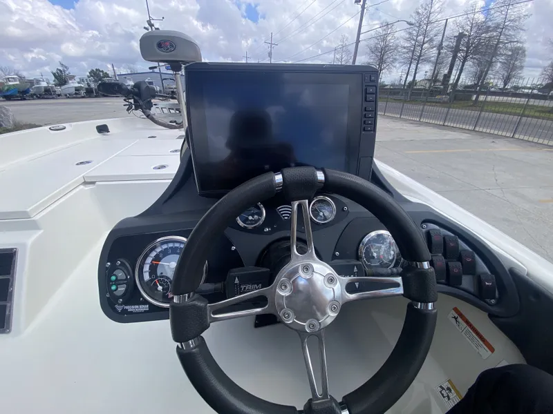 Slide: The Image of 2013 Ranger Z518i Intercoastal boat dashboard with steering wheel and instruments. - 12