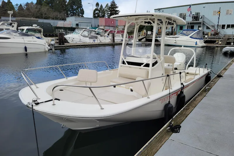 The Image of 2023 Boston Whaler 210 Montauk boat docked at a marina, showcasing sleek design. - 0