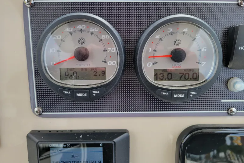 Slide: The Image of Dashboard of 2023 Boston Whaler 210 Montauk with speed and RPM gauges. - 13
