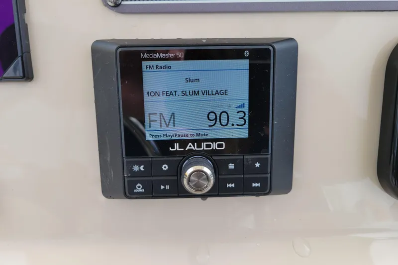 Slide: The Image of JL Audio MediaMaster 50 radio on 2023 Boston Whaler 210 Montauk, tuned to FM 90.3. - 14