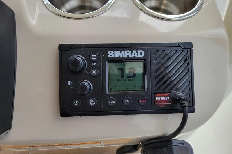 Slide: The Image of Simrad marine radio on 2023 Boston Whaler 210 Montauk boat dashboard. - 16