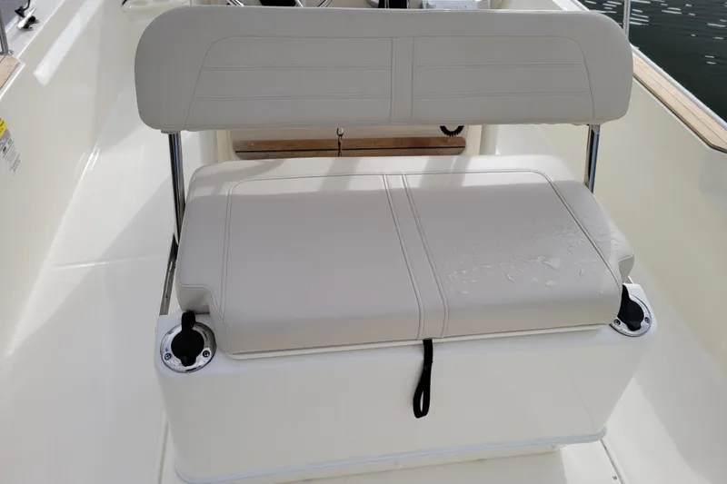 Slide: The Image of 2023 Boston Whaler 210 Montauk boat seat with cup holders and sleek design. - 21