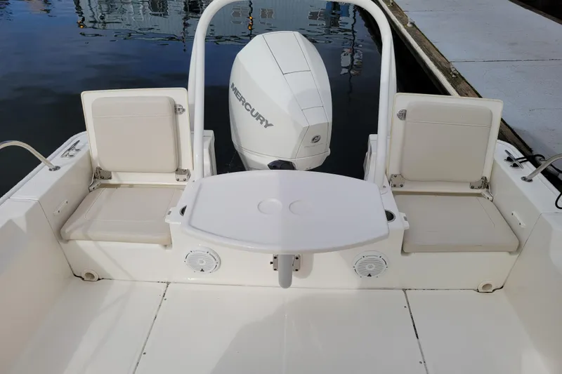 Slide: The Image of 2023 Boston Whaler 210 Montauk boat interior with seating and Mercury engine. - 22