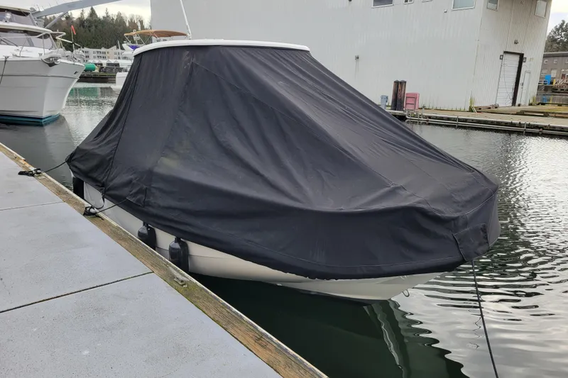 Slide: The Image of 2023 Boston Whaler 210 Montauk boat covered at marina dock. - 28