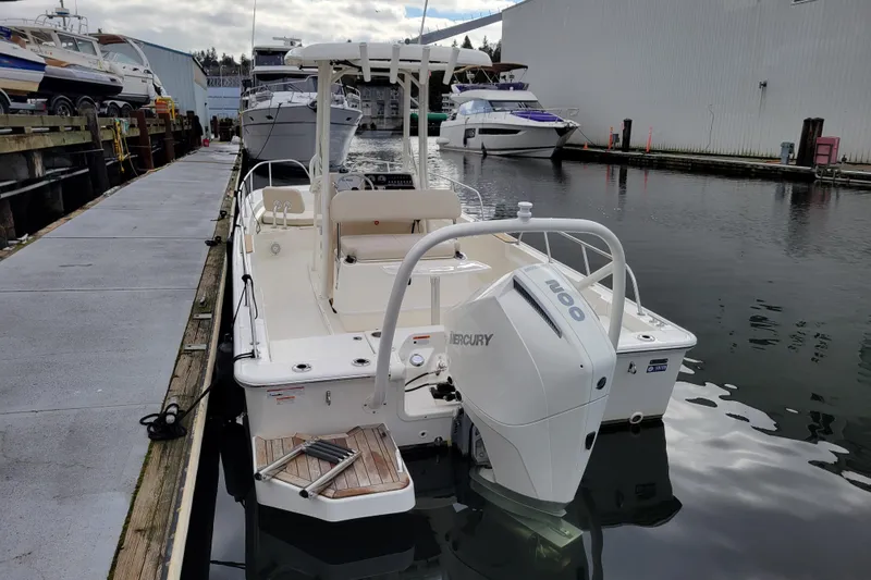 Slide: The Image of 2023 Boston Whaler 210 Montauk docked with Mercury outboard engine. - 3