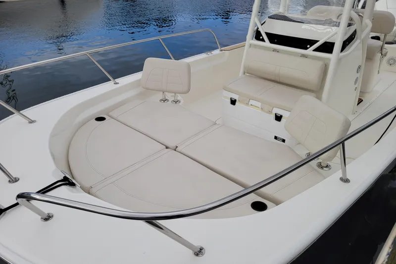Slide: The Image of 2023 Boston Whaler 210 Montauk boat interior with cushioned seating and railing. - 7
