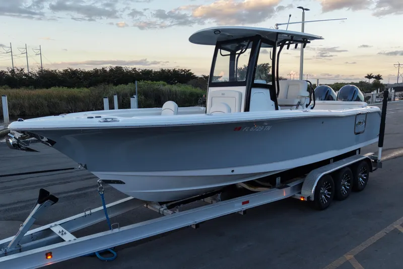 The Image of 2023 Sea Hunt Ultra 265 SE boat on trailer at sunset. - 0