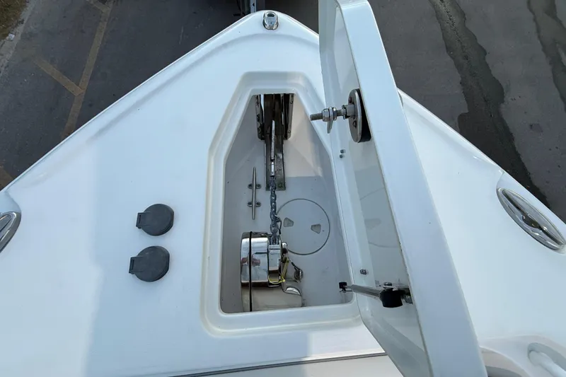 Slide: The Image of 2023 Sea Hunt Ultra 265 SE boat anchor compartment, open lid, top view. - 16
