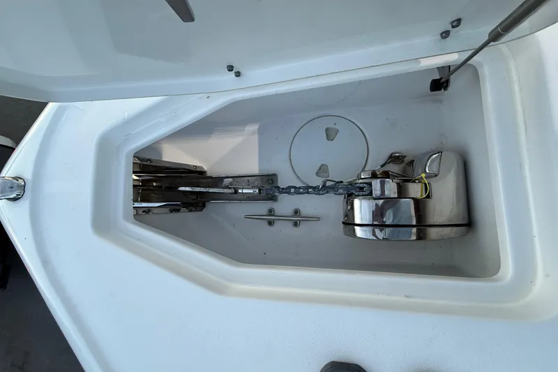 Slide: The Image of Anchor compartment of 2023 Sea Hunt Ultra 265 SE boat with chain and winch. - 17