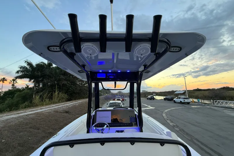 Slide: The Image of 2023 Sea Hunt Ultra 265 SE boat at sunset with modern dashboard and rod holders. - 18
