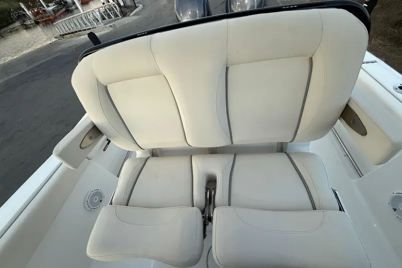 Slide: The Image of 2023 Sea Hunt Ultra 265 SE boat with white cushioned seating. - 21