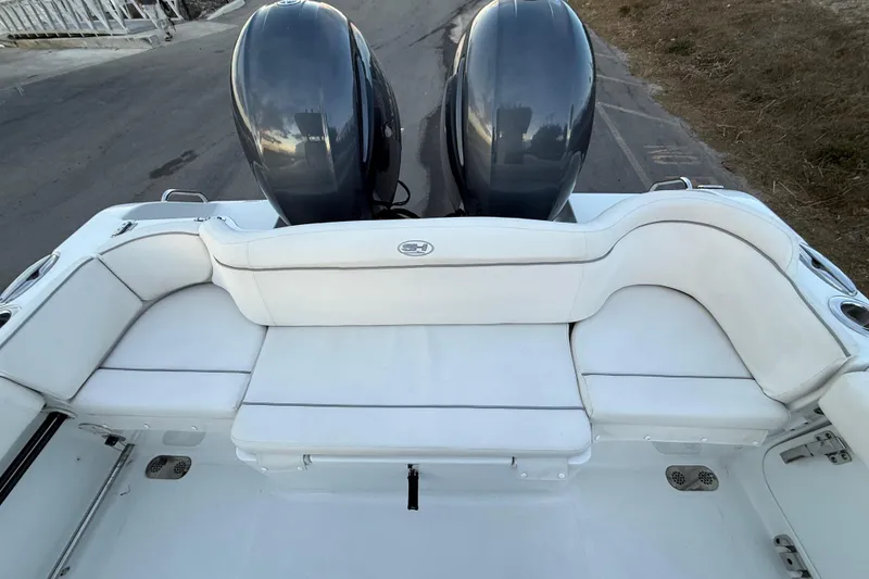 Slide: The Image of 2023 Sea Hunt Ultra 265 SE boat with dual engines and white seating. - 23