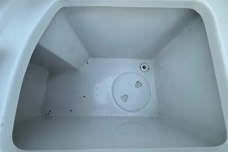 Slide: The Image of 2023 Sea Hunt Ultra 265 SE boat compartment, clean and empty interior view. - 25