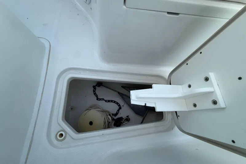 Slide: The Image of 2023 Sea Hunt Ultra 265 SE anchor storage compartment with chain and rope. - 27