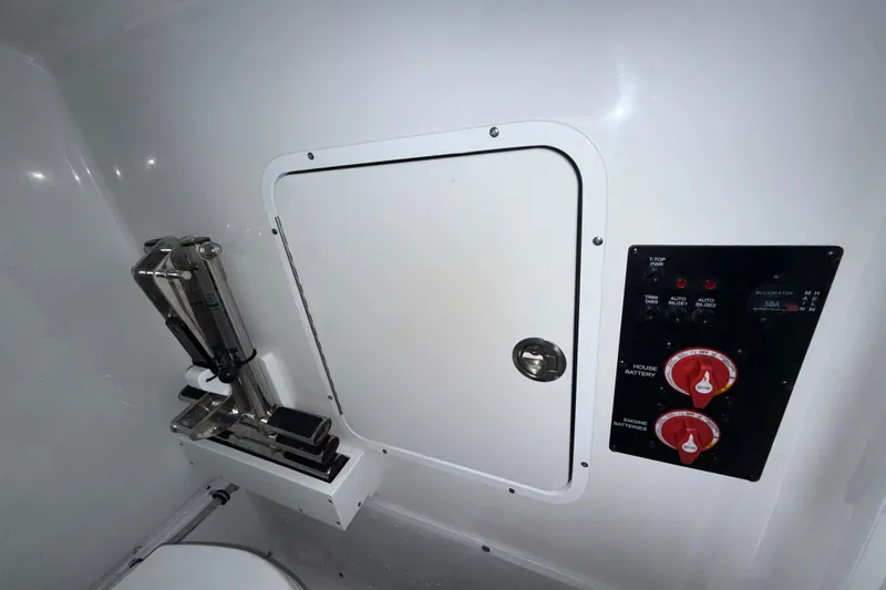 Slide: The Image of 2023 Sea Hunt Ultra 265 SE control panel and storage compartment. - 29
