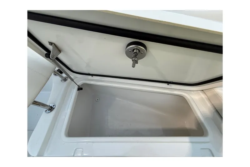 Slide: The Image of 2023 Sea Hunt Ultra 265 SE storage compartment with open lid and secure latch. - 31