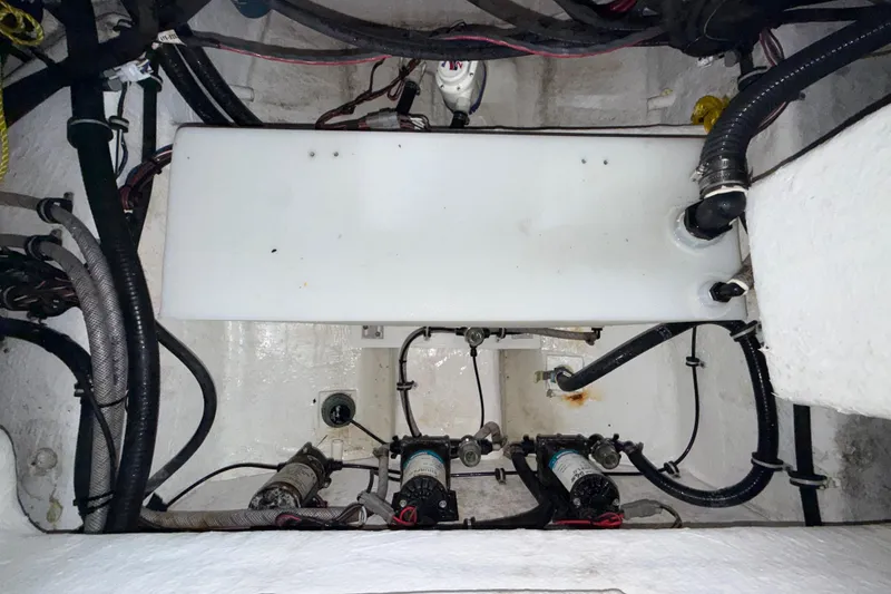 Slide: The Image of Engine compartment of 2023 Sea Hunt Ultra 265 SE boat, showcasing wiring and components. - 33