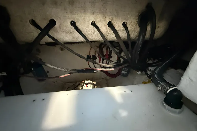 Slide: The Image of 2023 Sea Hunt Ultra 265 SE boat wiring and plumbing compartment. - 36