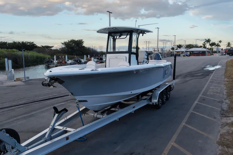 Slide: The Image of 2023 Sea Hunt Ultra 265 SE boat on trailer at marina dockside. - 4
