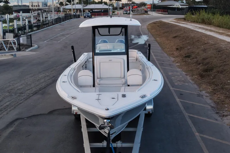 Slide: The Image of 2023 Sea Hunt Ultra 265 SE boat on trailer, parked near marina. - 5