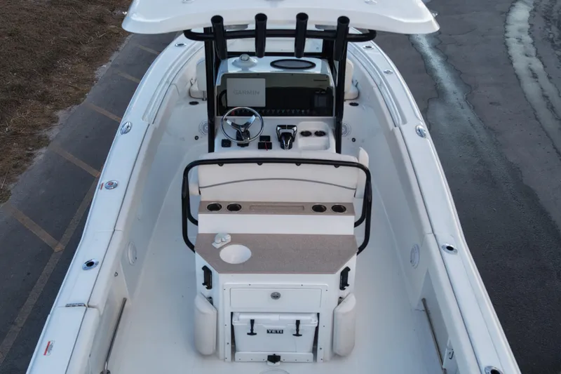 Slide: The Image of 2023 Sea Hunt Ultra 265 SE boat interior with helm and seating area. - 7