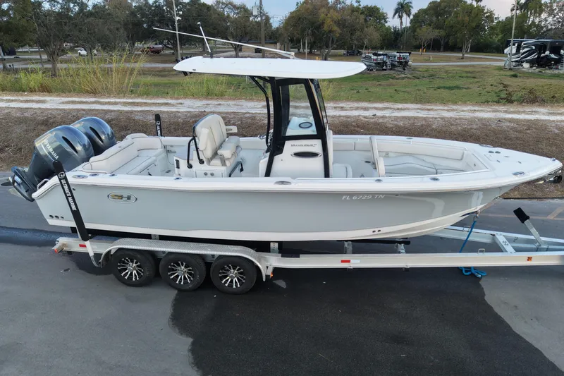 Slide: The Image of 2023 Sea Hunt Ultra 265 SE boat on trailer, featuring dual engines. - 8