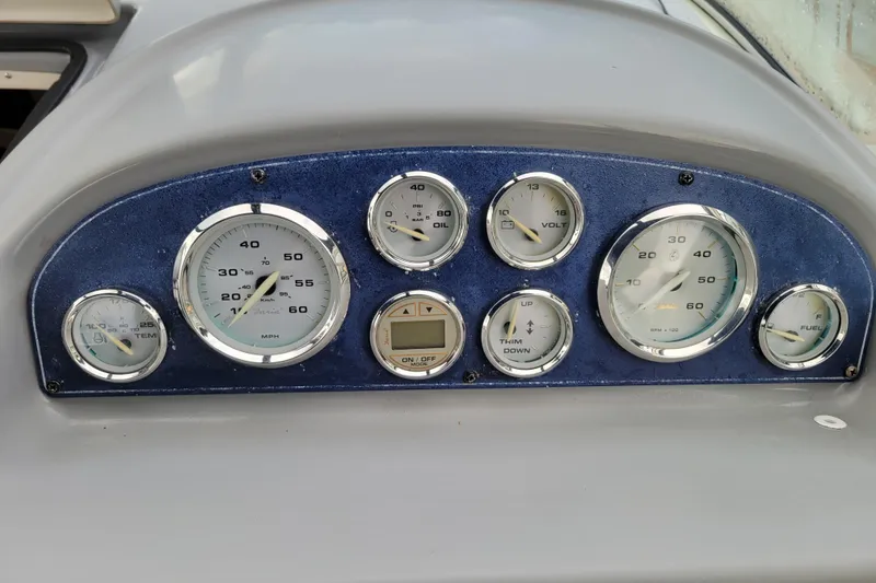 Slide: The Image of Dashboard of a 2004 Bayliner 285 boat with various gauges and controls. - 11