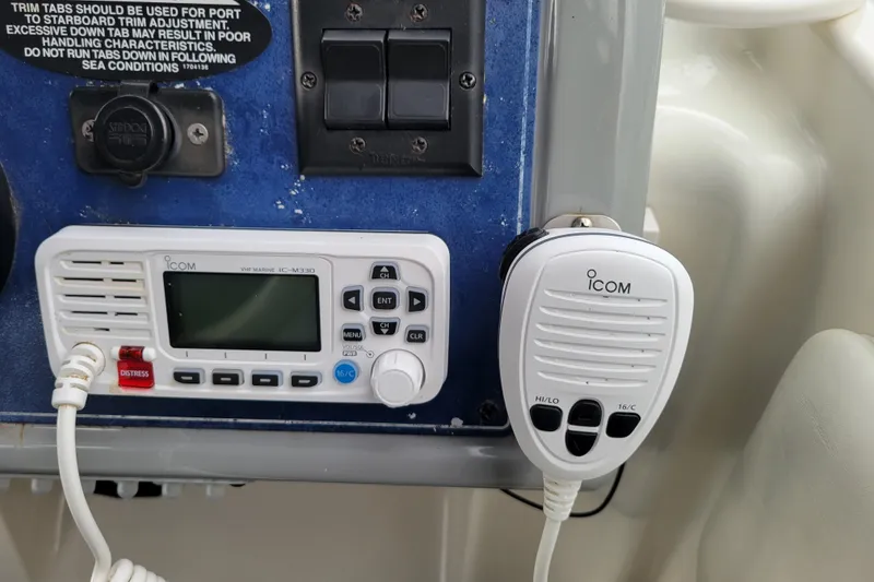 Slide: The Image of VHF marine radio and controls on a 2004 Bayliner 285 boat dashboard. - 13