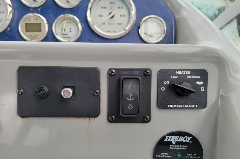 Slide: The Image of Control panel of a 2004 Bayliner 285 boat with gauges and heater settings. - 14