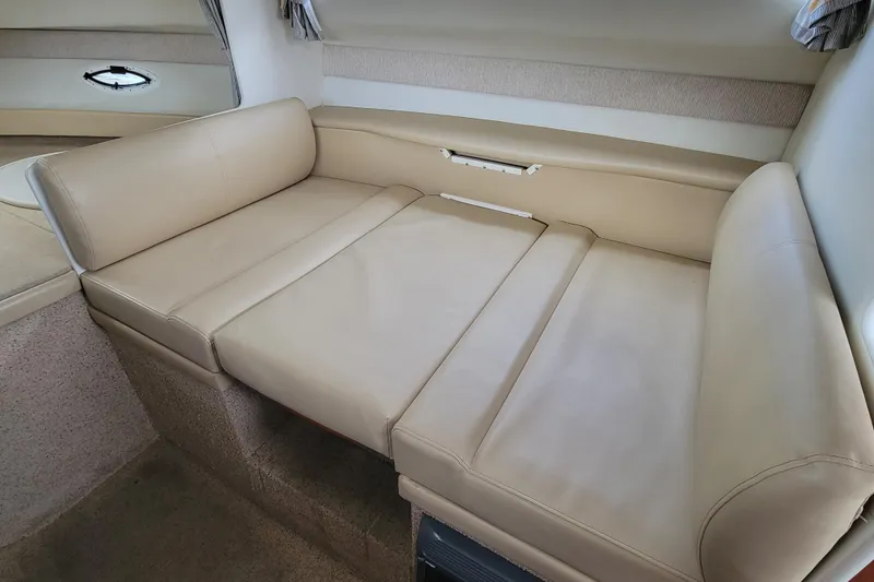 Slide: The Image of Interior storage cabinet of a 2004 Bayliner 285 boat, featuring wooden shelves. - 18