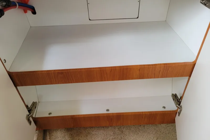 Slide: The Image of 2004 Bayliner 285 interior with beige seating and wooden table. - 20