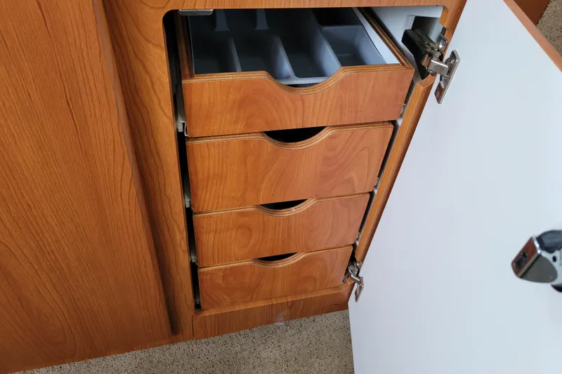 Slide: The Image of 2004 Bayliner 285 interior with beige leather seating and compact design. - 21