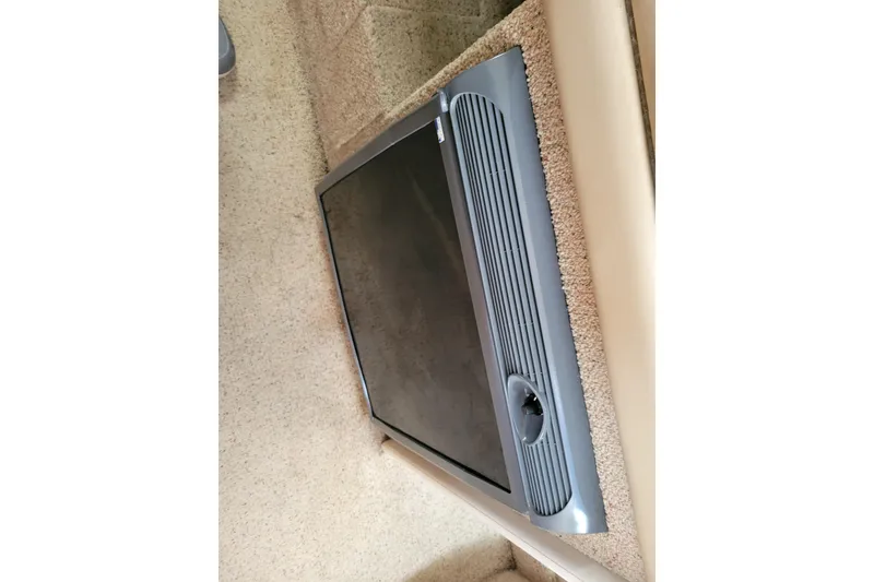 Slide: The Image of 2004 Bayliner 285 cabin interior with a built-in refrigerator. - 22