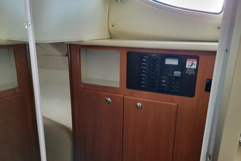 Slide: The Image of Compact bathroom in 2004 Bayliner 285 boat with toilet, sink, and porthole window. - 25