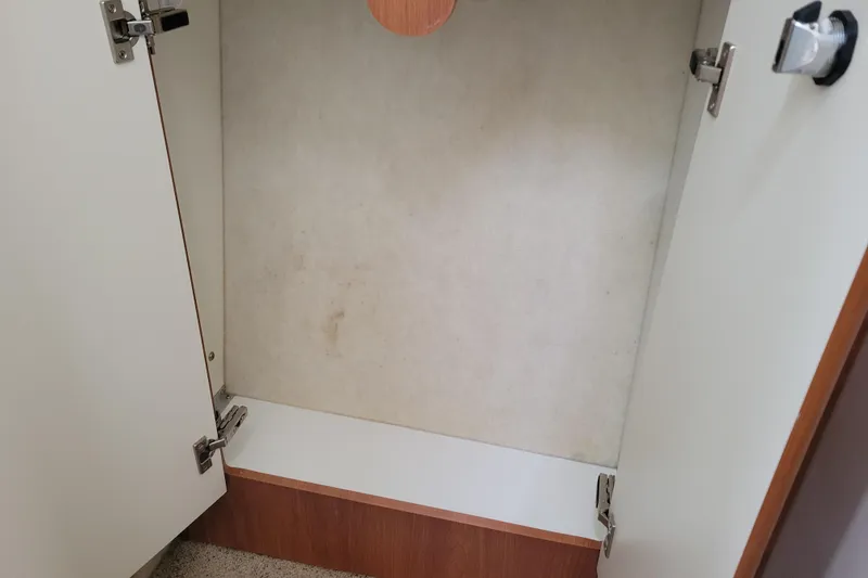 Slide: The Image of 2004 Bayliner 285 cabin interior with striped cushion and wooden cabinetry. - 26