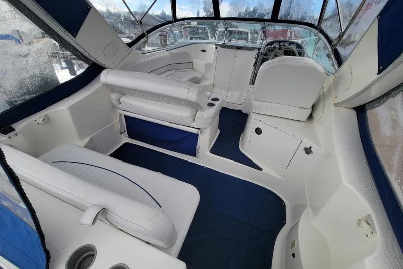 Slide: The Image of 2004 Bayliner 285 boat interior with white seating and blue accents. - 6