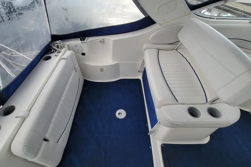 Slide: The Image of 2004 Bayliner 285 boat interior with white seating and blue carpet. - 8