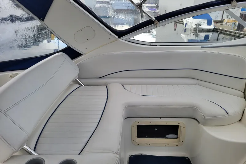 Slide: The Image of Interior seating of a 2004 Bayliner 285 boat with white upholstery. - 9