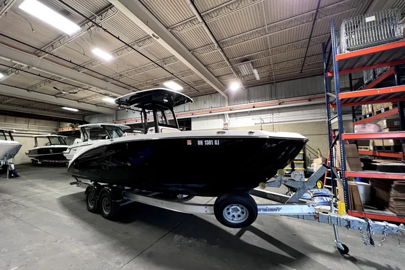 Slide: The Image of 2023 Yamaha Boats 255 FSH Sport E in warehouse, on trailer, side view. - 1