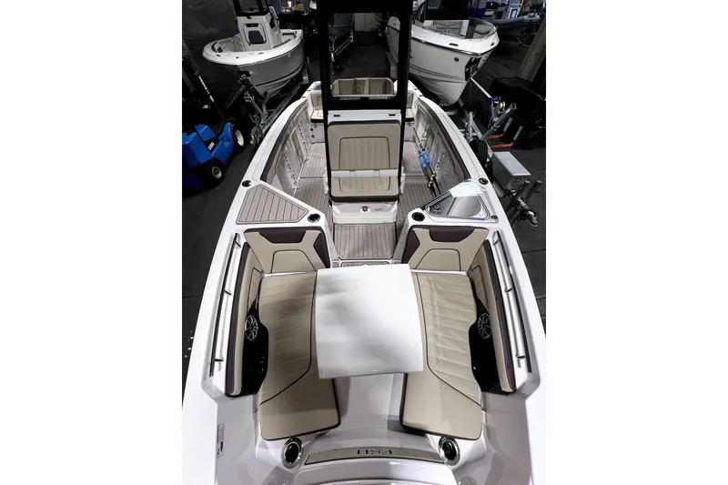Slide: The Image of 2023 Yamaha Boats 255 FSH Sport E interior with seating and table, showcasing luxury design. - 11