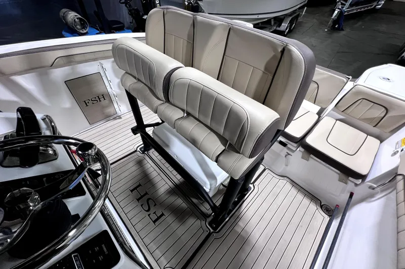 Slide: The Image of 2023 Yamaha Boats 255 FSH Sport E interior with helm and seating area. - 14