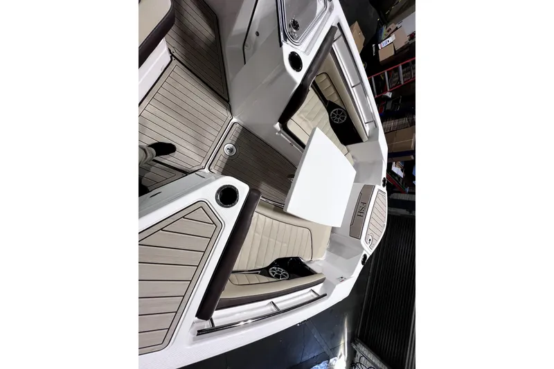 Slide: The Image of 2023 Yamaha Boats 255 FSH Sport E interior with seating and table, showcasing modern design. - 16
