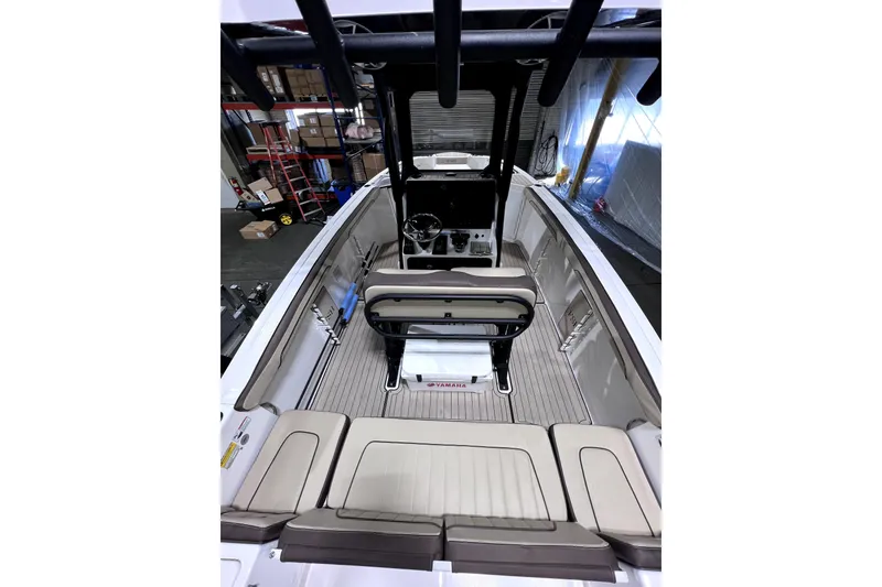 Slide: The Image of 2023 Yamaha Boats 255 FSH Sport E interior with seating and helm, showcasing modern design. - 24