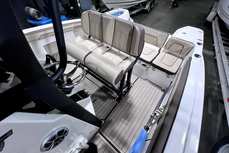 Slide: The Image of 2023 Yamaha Boats 255 FSH Sport E interior with seating and steering wheel. - 25